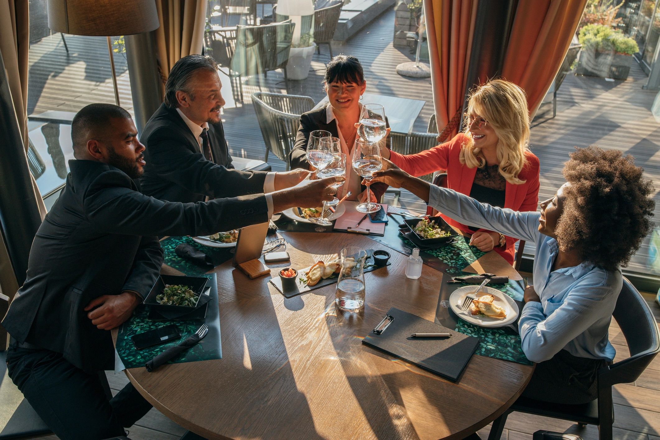 Group toasting during a restaurant celebration