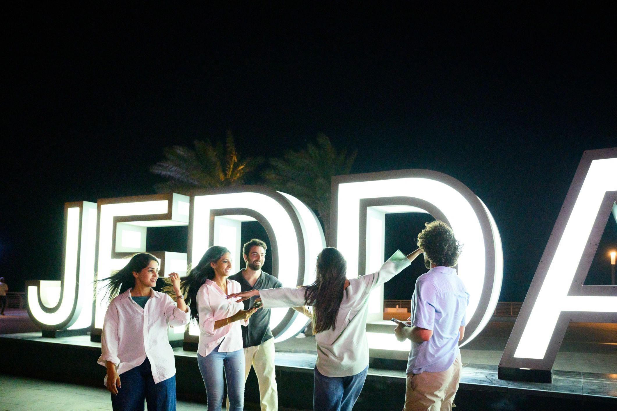 Group celebrating together in a vibrant night scene